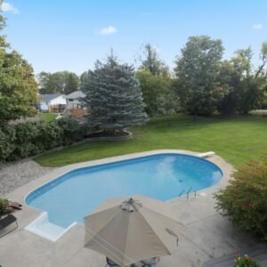 an aerial view of a backyard with a swimming pool
